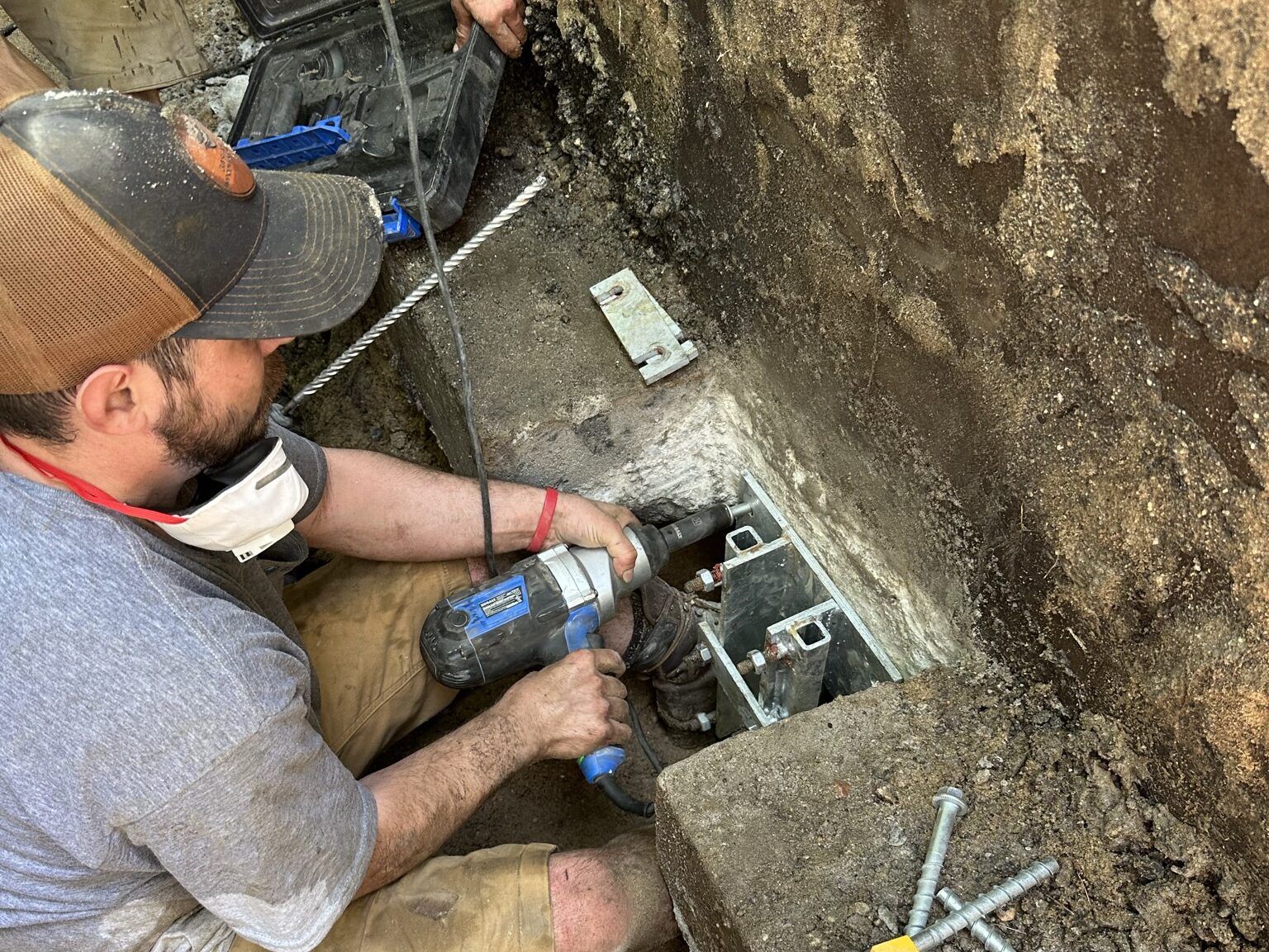 A plumber repairing a sump pump in a flooded basement