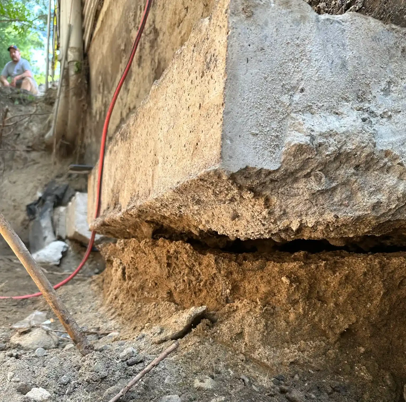 A plumber repairing a sump pump in a flooded basement